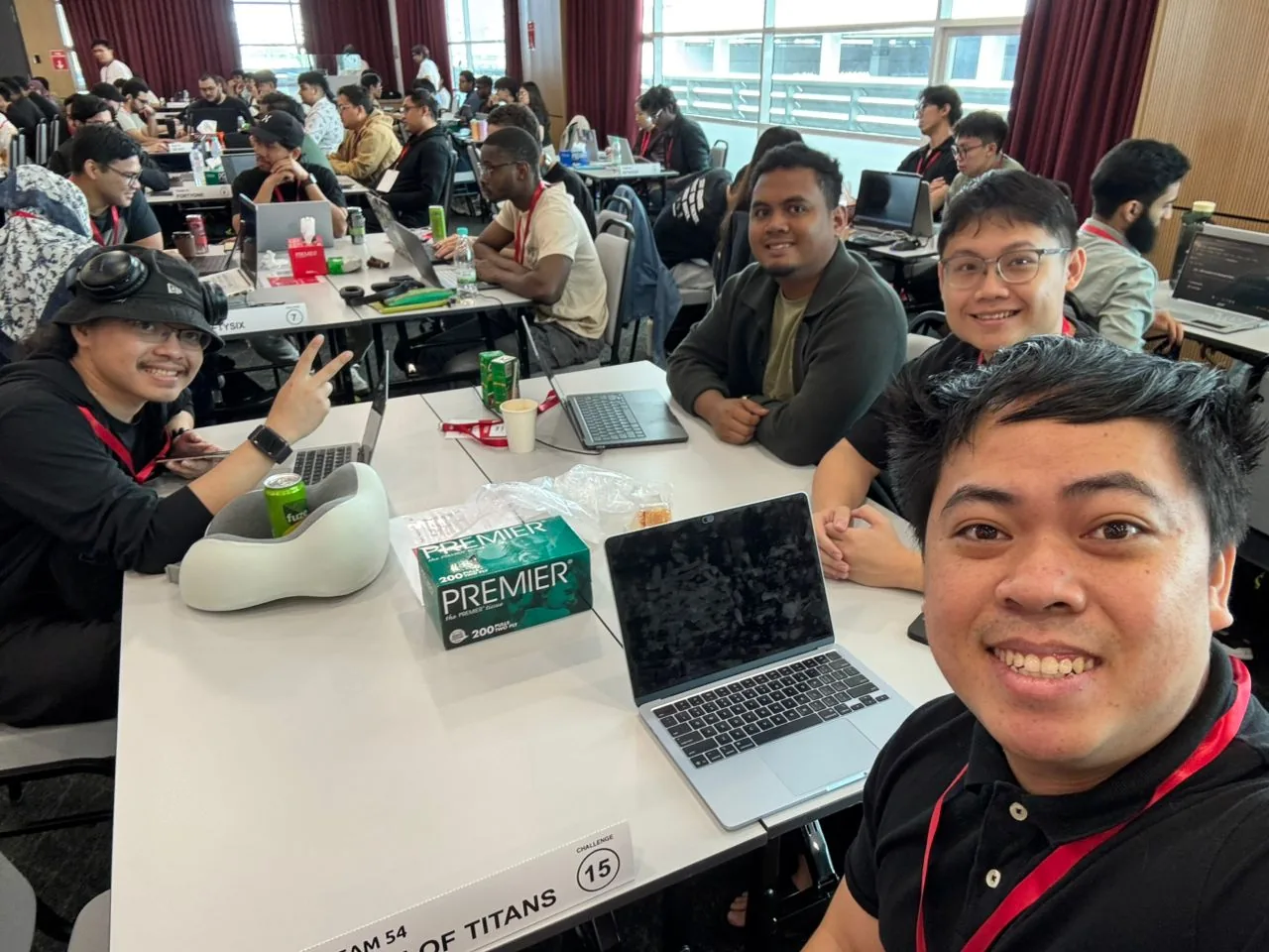 Hunter Ho and teammates building at a hackathon table