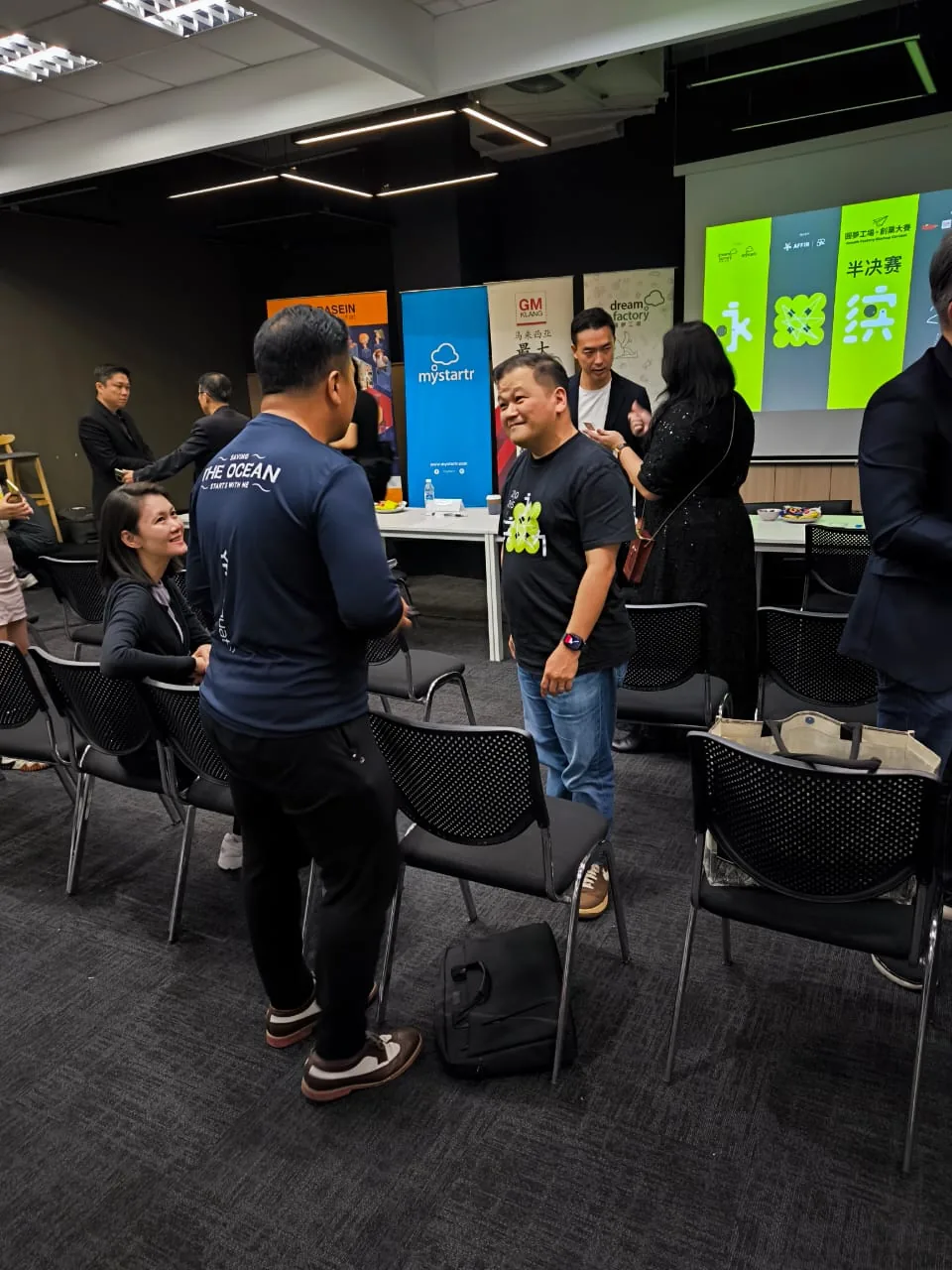 Startup competition networking room with founders and judges