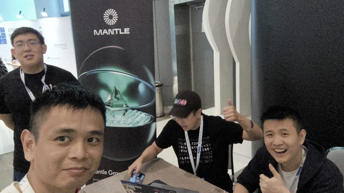Early hackathon team working with laptops at shared table