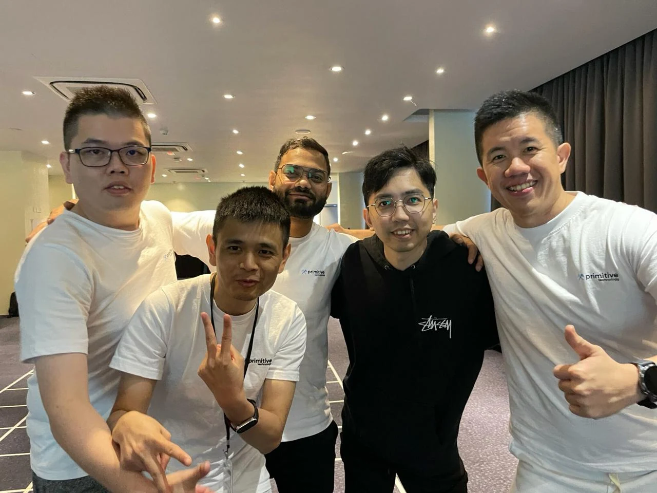 Small team group photo with Primitive branded shirts