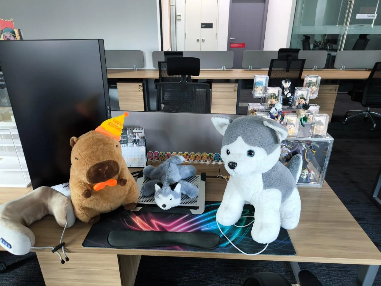 Office desk decorated with plush toys and figurines