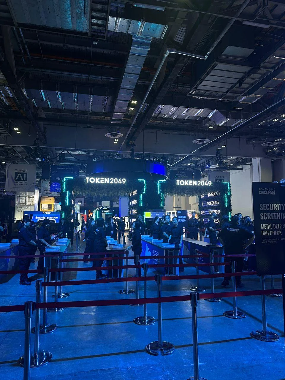TOKEN2049 entrance area with security screening and blue lights