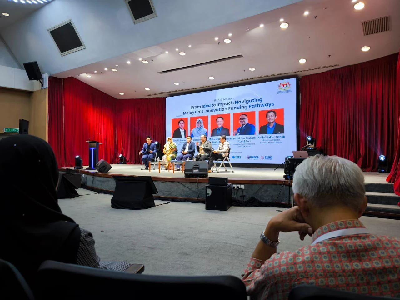 Panel discussion on stage about Malaysia innovation funding