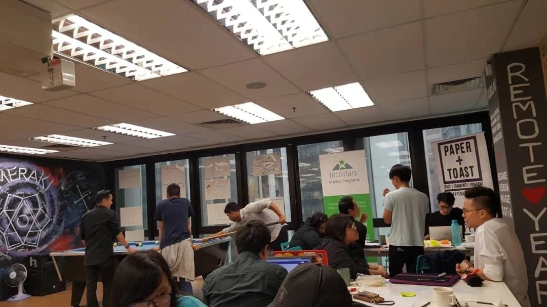 Indoor meetup workspace with community banners and active discussions