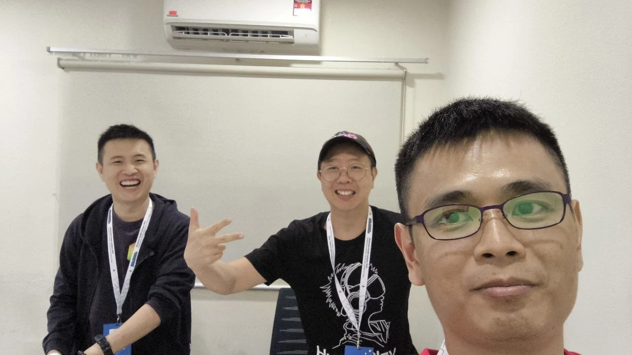 Indoor meetup selfie with lanyards after a community workshop session
