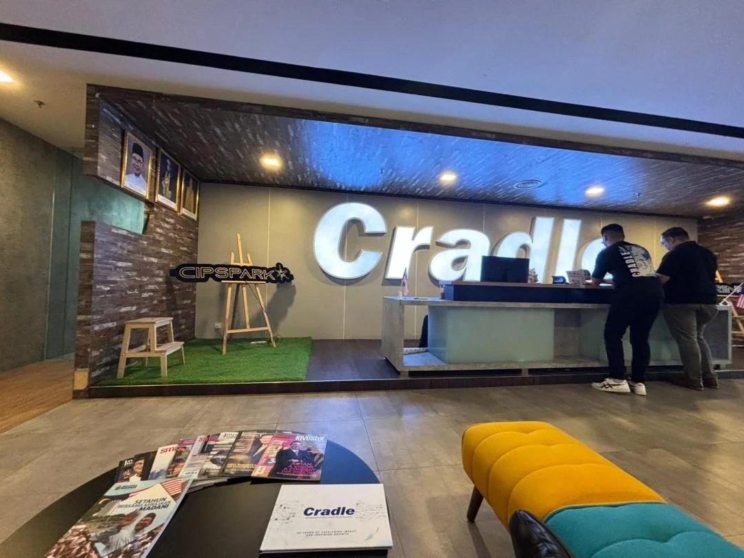 Reception area with Cradle branding and CIP SPARK signage